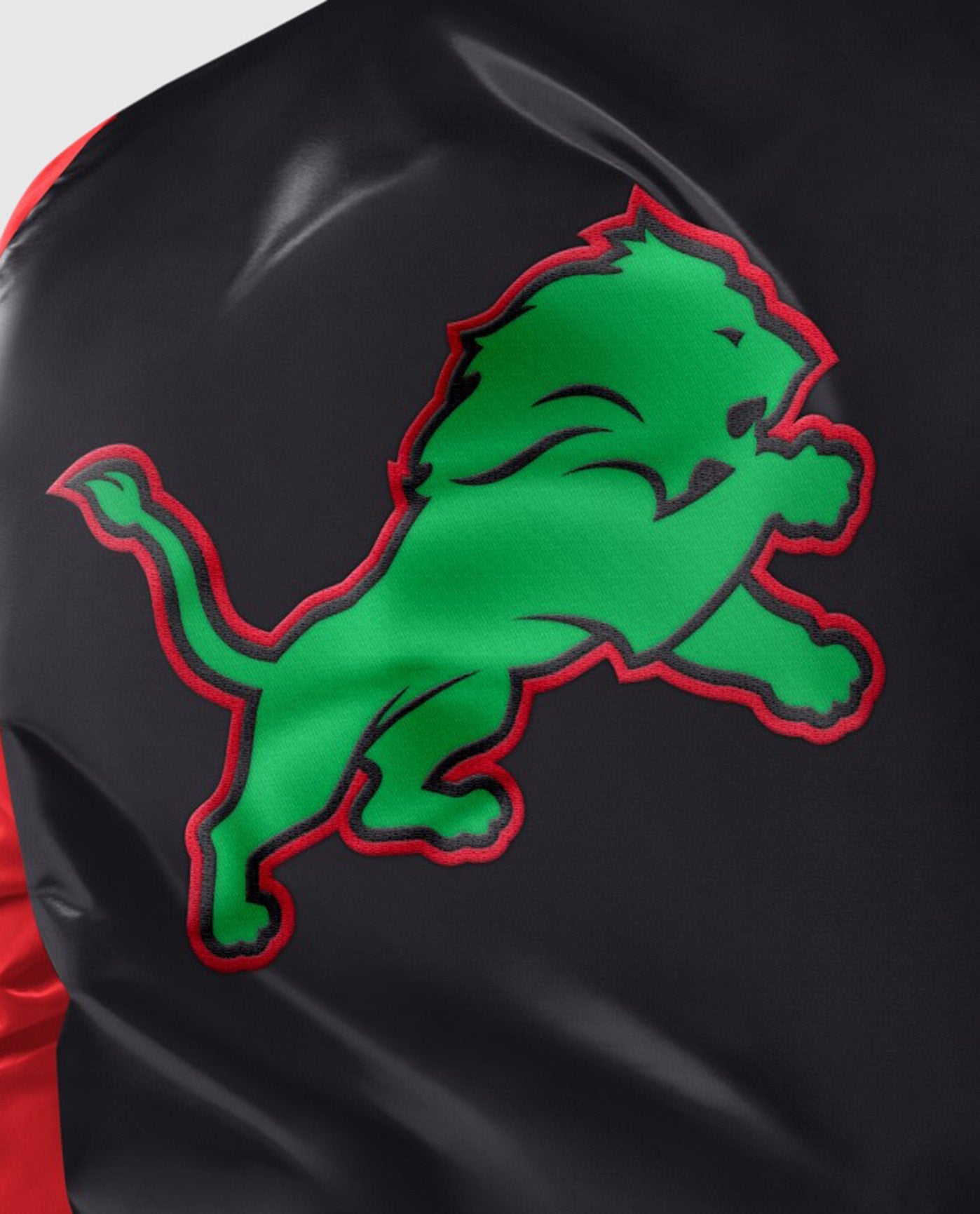 Detail View of Starter Black Detroit Lions Black History Month Quilted Lining Starter Satin Full-Snap Jacket | STR DETROIT LIONS BLACK